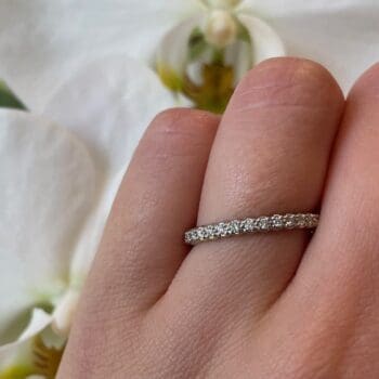 Diamond Eternity Band 14k white gold size 7 shown on a hand
